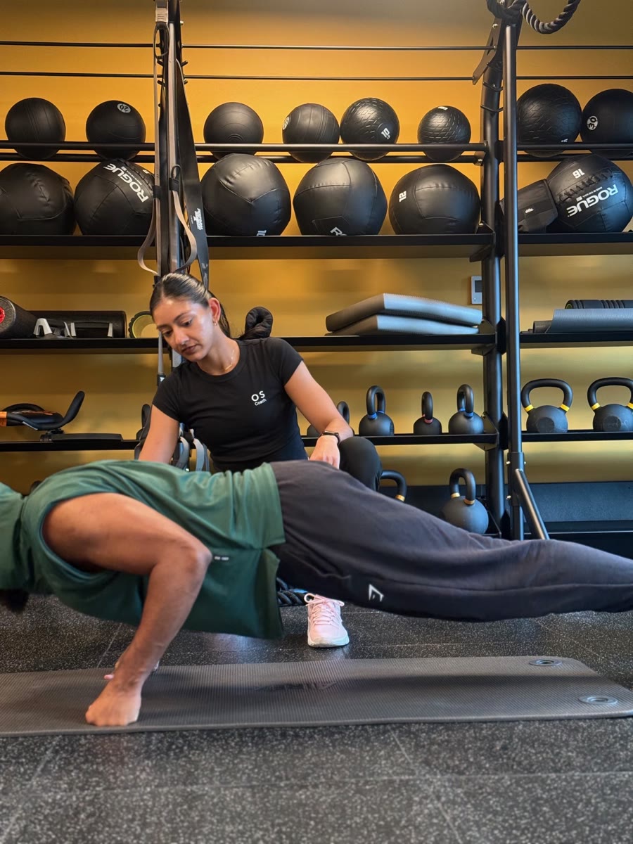 Amrit Kaur supporting a client through floor work